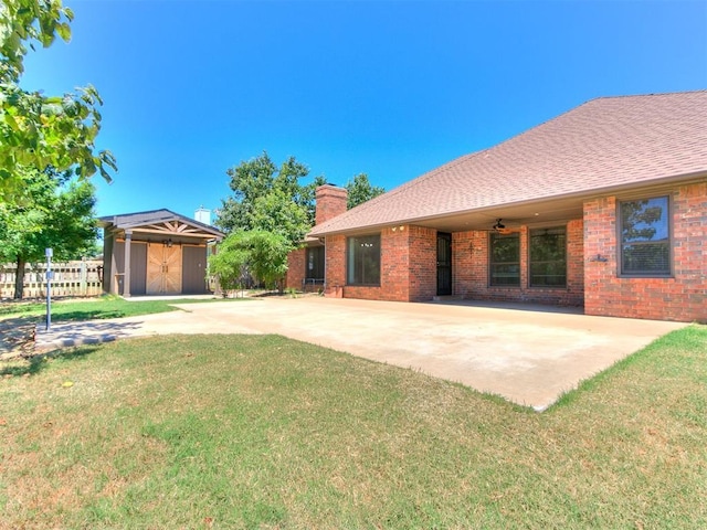 exterior space featuring ceiling fan and a storage unit