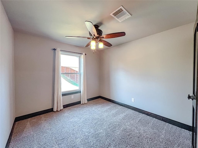 spare room featuring ceiling fan and light colored carpet