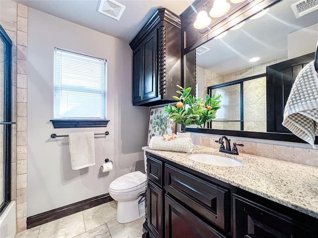 full bathroom featuring vanity, toilet, and bath / shower combo with glass door