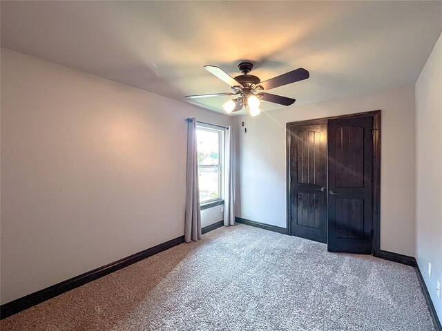 unfurnished bedroom with light carpet, a closet, and ceiling fan