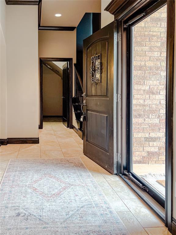 hall with light tile patterned floors