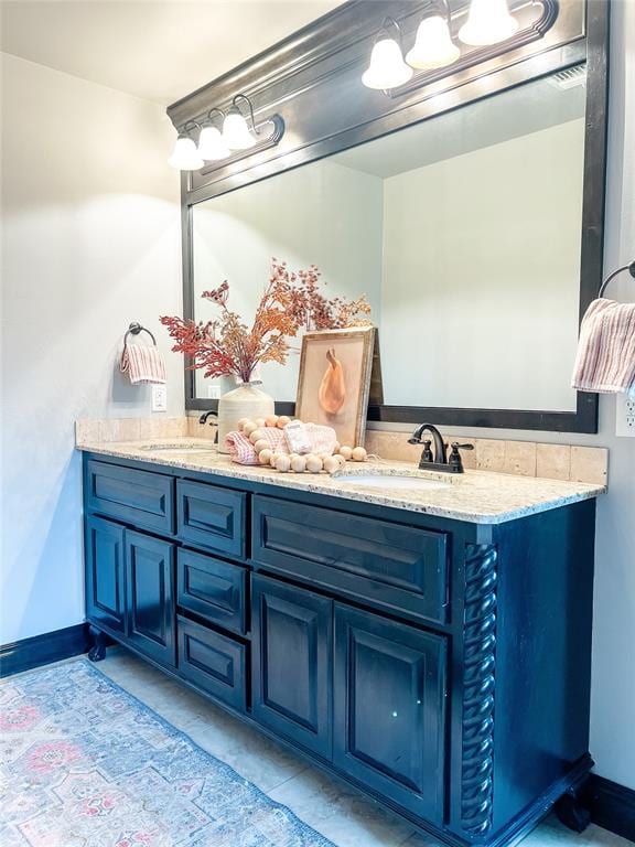 bathroom with tile patterned floors and vanity