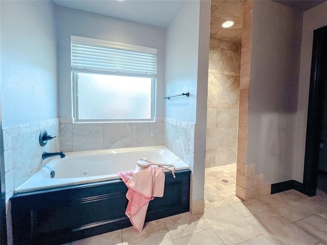 bathroom featuring tile patterned flooring and separate shower and tub