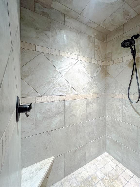 bathroom with a tile shower