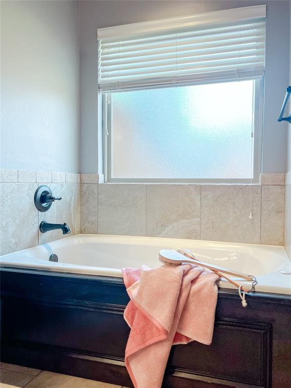 bathroom featuring tile patterned floors and a bathtub