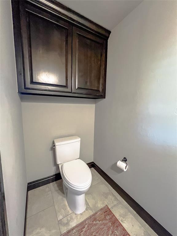 bathroom featuring tile patterned floors and toilet