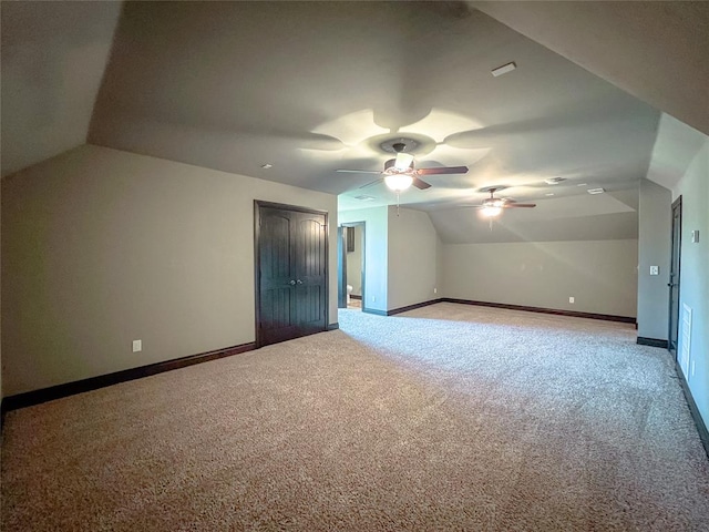 additional living space with carpet flooring and lofted ceiling