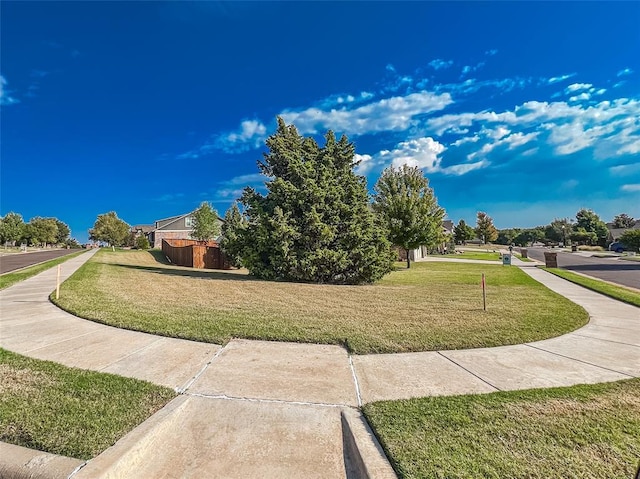 view of home's community with a lawn