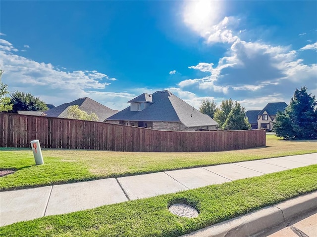 view of side of property with a lawn