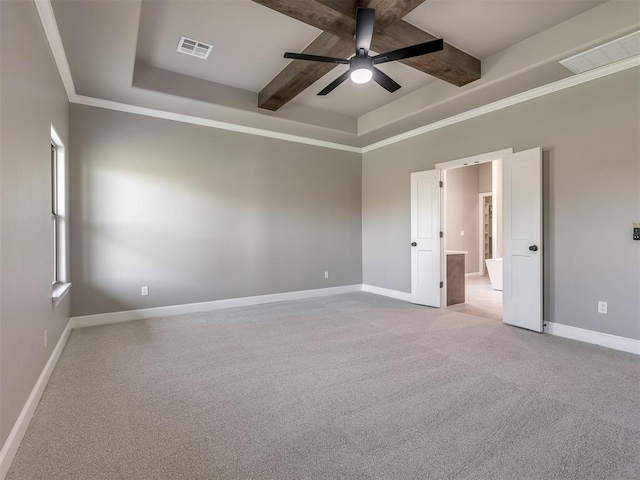 carpeted spare room featuring baseboards, visible vents, and a raised ceiling