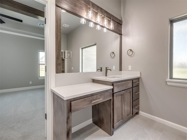 bathroom featuring a healthy amount of sunlight, visible vents, baseboards, and vanity