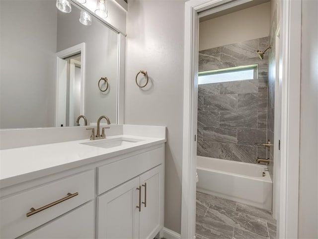 full bath featuring washtub / shower combination, marble finish floor, and vanity