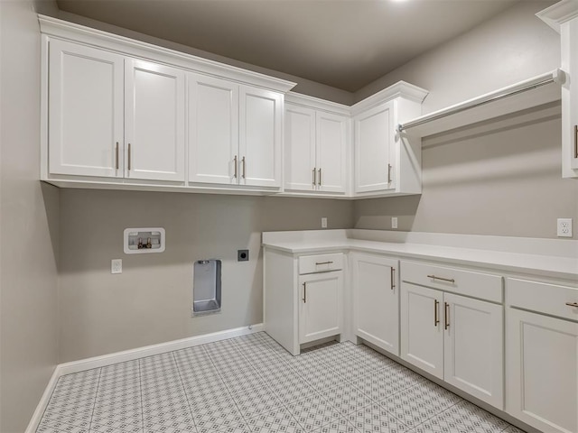 laundry room with cabinet space, hookup for a washing machine, baseboards, and hookup for an electric dryer