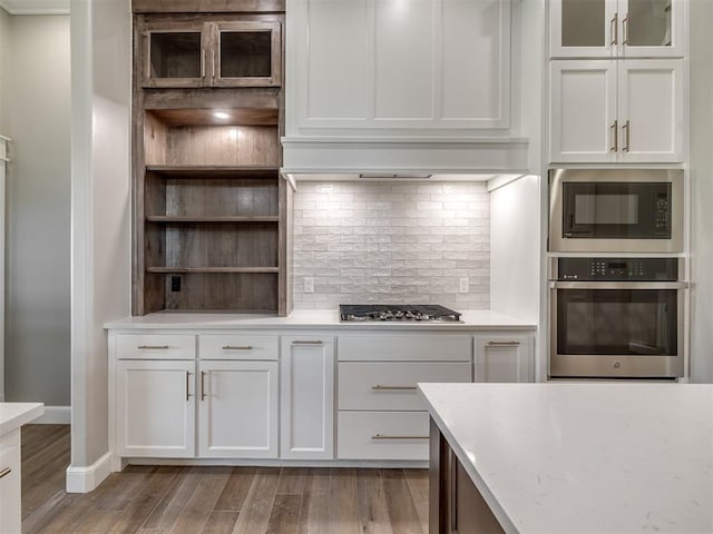 kitchen featuring open shelves, backsplash, appliances with stainless steel finishes, white cabinets, and light wood-type flooring