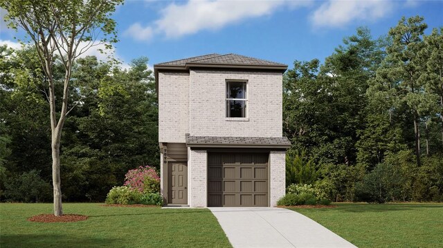 view of front of property with a front yard and a garage