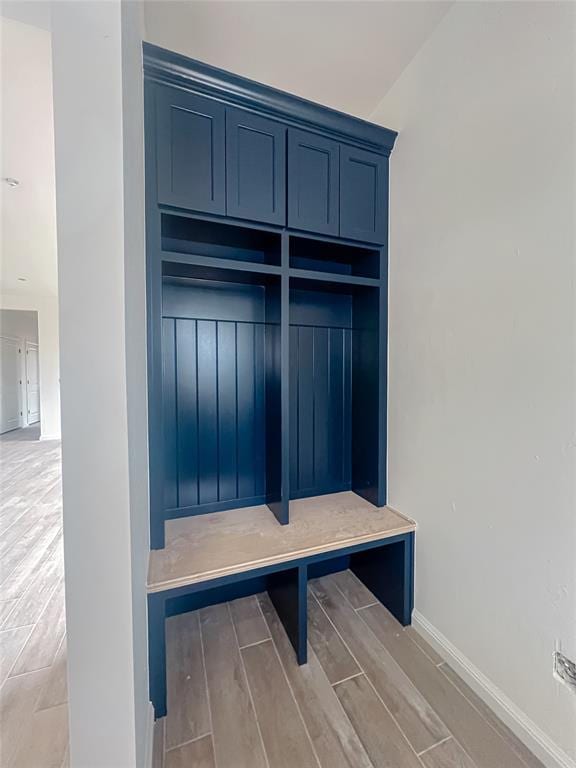 mudroom with wood finish floors and baseboards