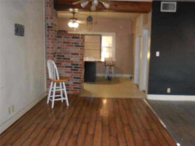 interior space featuring ceiling fan, built in features, and dark wood-type flooring