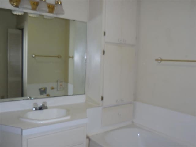 bathroom featuring a washtub and vanity