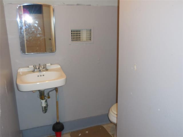 bathroom with sink and toilet