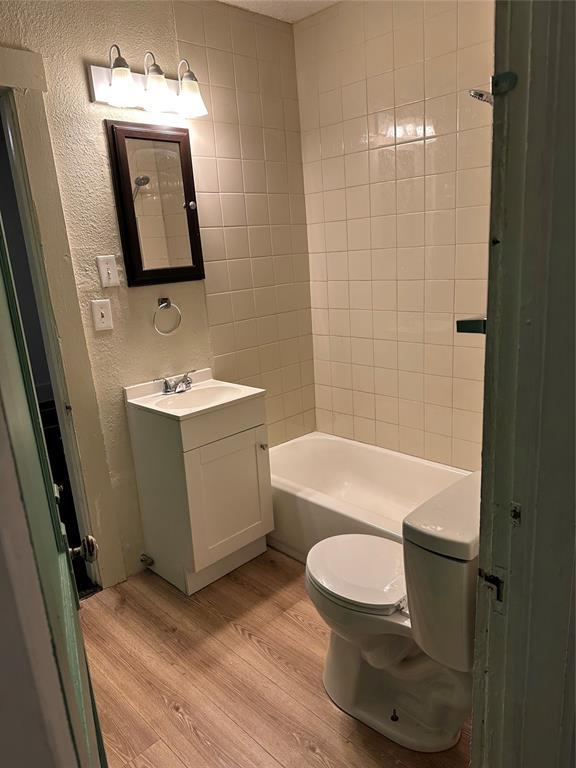 bathroom featuring wood-type flooring, vanity, and toilet