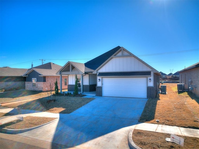 view of front of house with central AC unit and a garage