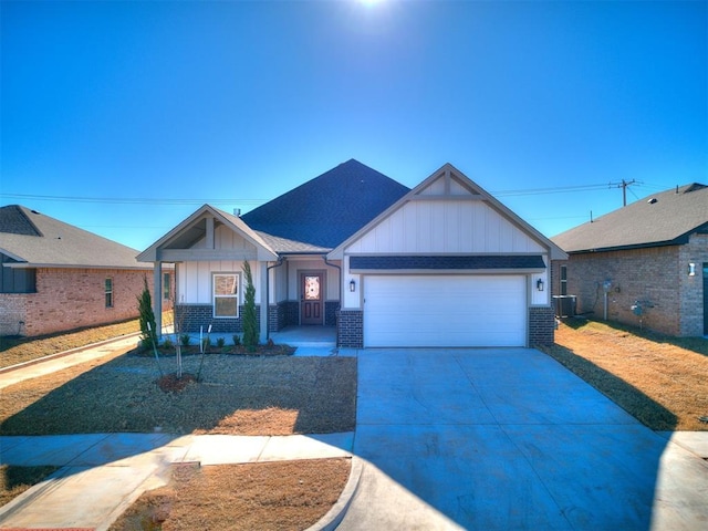 view of front of house with central air condition unit and a garage