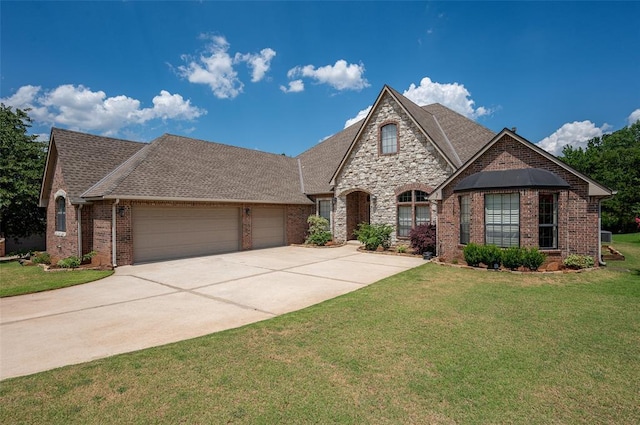 view of front of house with a front yard and a garage