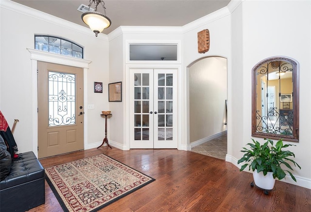 entryway featuring french doors, crown molding, and hardwood / wood-style floors