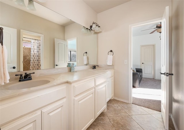 bathroom with tile patterned flooring, vanity, and ceiling fan