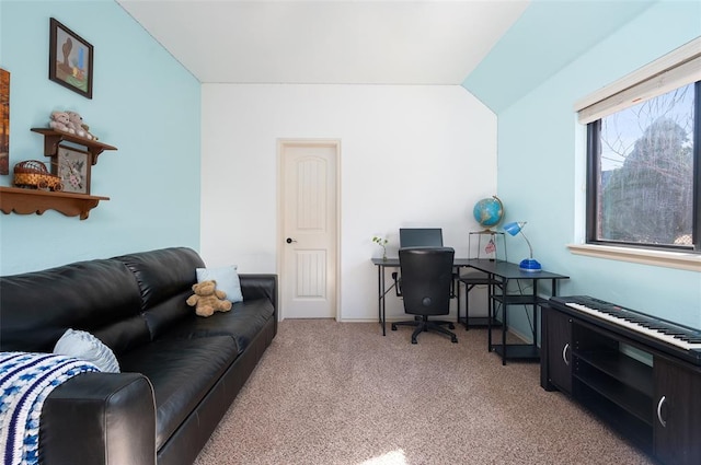 carpeted office space featuring vaulted ceiling