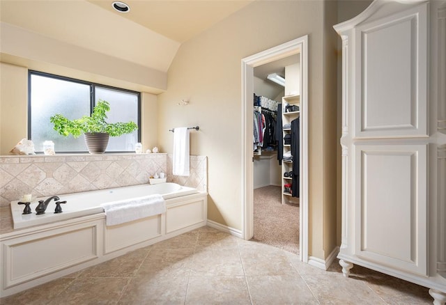 bathroom featuring a bathing tub and lofted ceiling