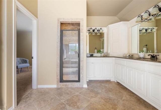 bathroom featuring vanity, an enclosed shower, and vaulted ceiling