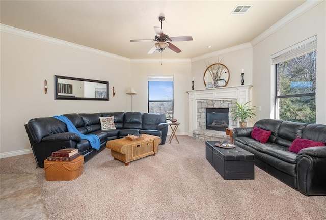 carpeted living room featuring a stone fireplace, ceiling fan, and ornamental molding