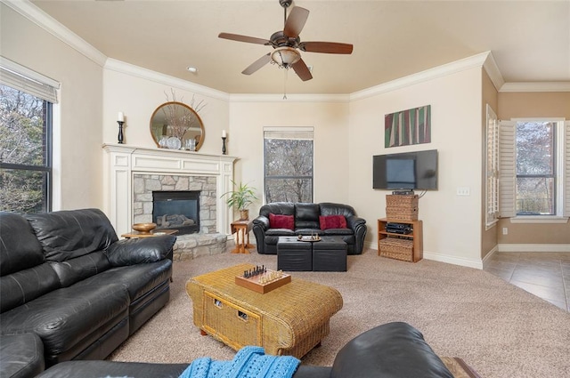 carpeted living room featuring a fireplace, ceiling fan, and crown molding