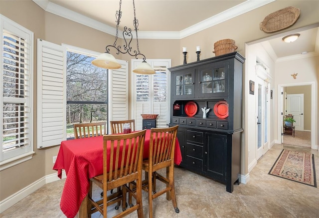 dining space with a wealth of natural light and crown molding