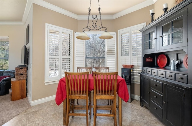 dining area with plenty of natural light, ornamental molding, and light tile patterned flooring