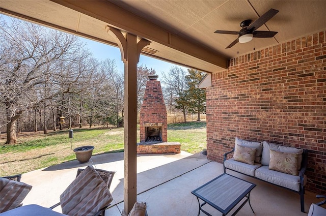 view of patio / terrace featuring an outdoor living space with a fireplace and ceiling fan