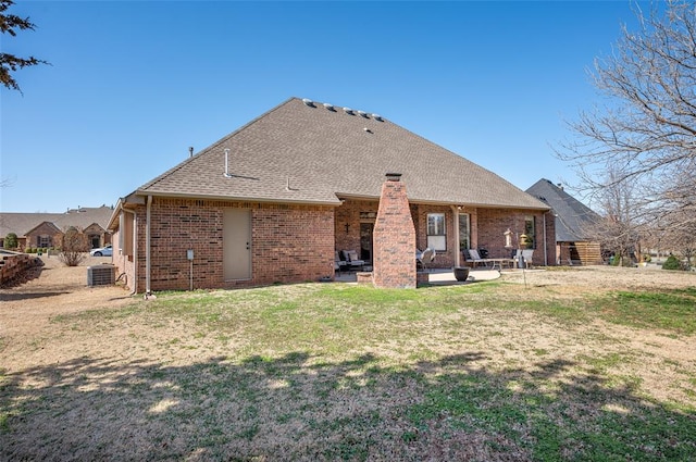 back of property with a patio, central AC unit, and a lawn