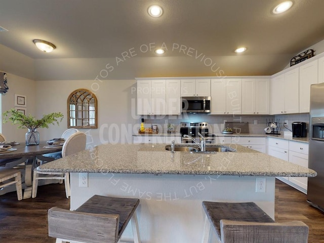 kitchen featuring sink, white cabinets, an island with sink, and appliances with stainless steel finishes