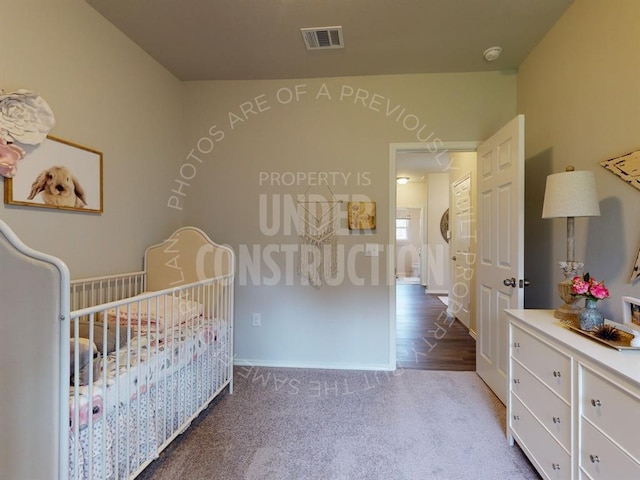 bedroom with a crib and light carpet