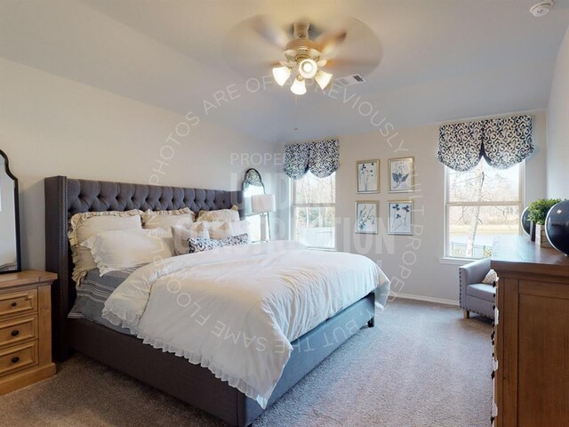 bedroom with multiple windows, light colored carpet, and ceiling fan