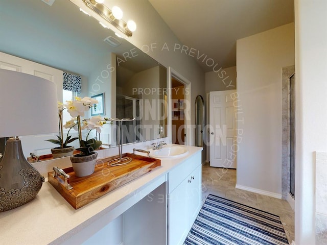 bathroom with vanity, tile patterned floors, and a shower with shower door