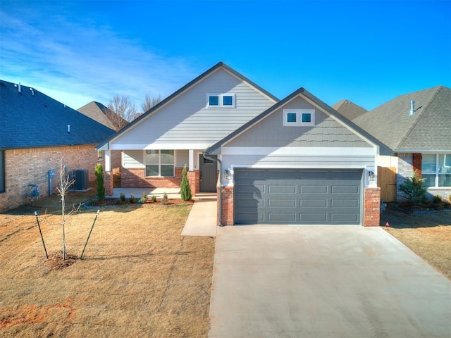 craftsman-style house with a front yard, a garage, and central air condition unit