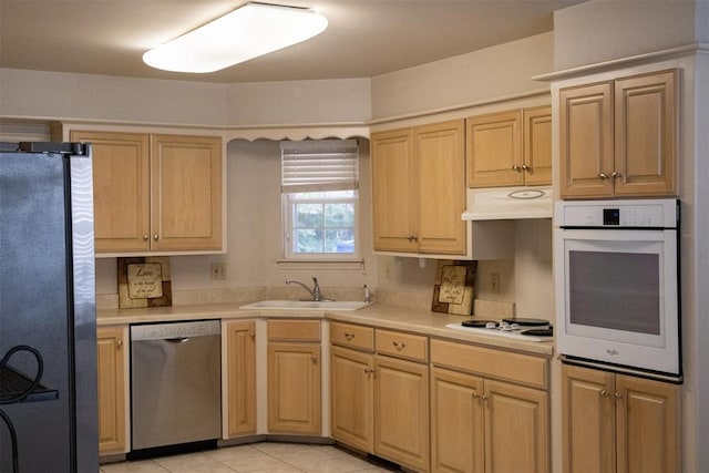 kitchen featuring light brown cabinetry, appliances with stainless steel finishes, and sink