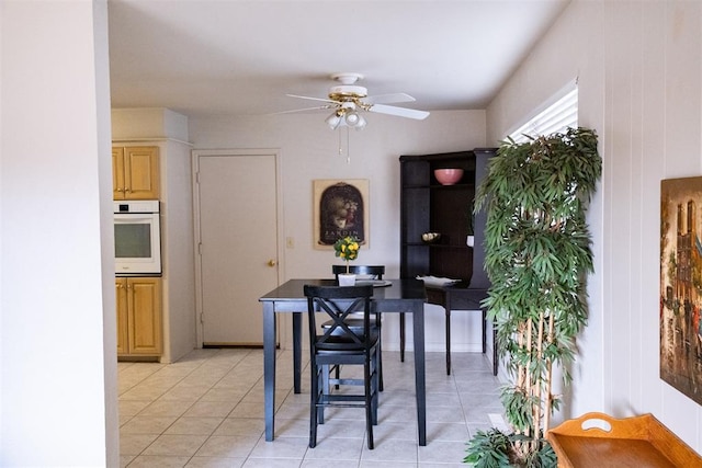 tiled dining area with ceiling fan