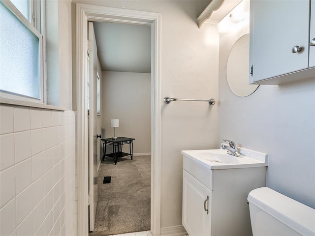 bathroom featuring toilet and vanity