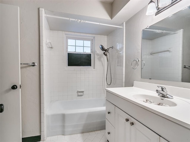 bathroom featuring vanity, tiled shower / bath, and tile patterned flooring