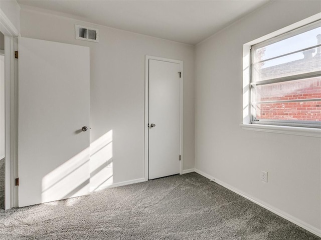 unfurnished bedroom with multiple windows and carpet