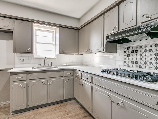 kitchen featuring gray cabinets, sink, and gas cooktop