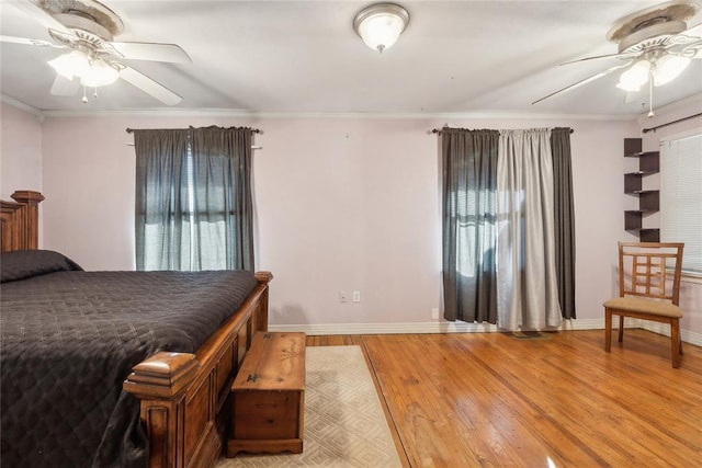 bedroom featuring ceiling fan, ornamental molding, and light hardwood / wood-style flooring